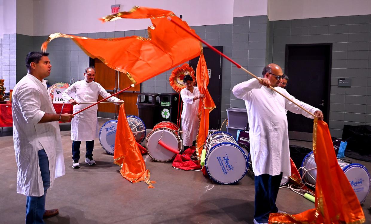 Members of the Dhol-Tasha-Lezim Group prepare flags before performing at the India Society of Worcester's India Day festival at the DCU Center Saturday.
