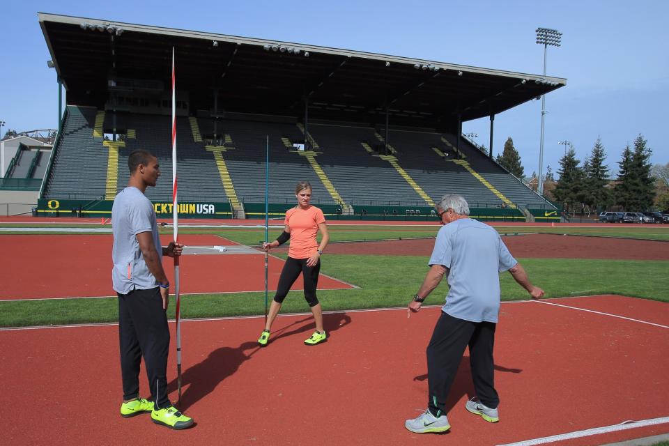 <p>Coach Harry Marra (R) talks with Ashton Eaton (L) of the USA Track and Field Team and his fiancee Brianne Theisen (C), Canadian Heptathlete, as they train with the javelin at Hayward Field on the campus of the University of Oregon on April 12, 2013 in Eugene, Oregon. Eaton is the reigning Olympic gold medalist and world record holder in the decathlon. (Photo by Doug Pensinger/Getty Images) </p>