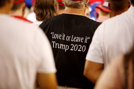 FILE PHOTO: A supporter of U.S. President Trump wears a shirt with the message of "Love It or Leave It" at a campaign rally in Greenville