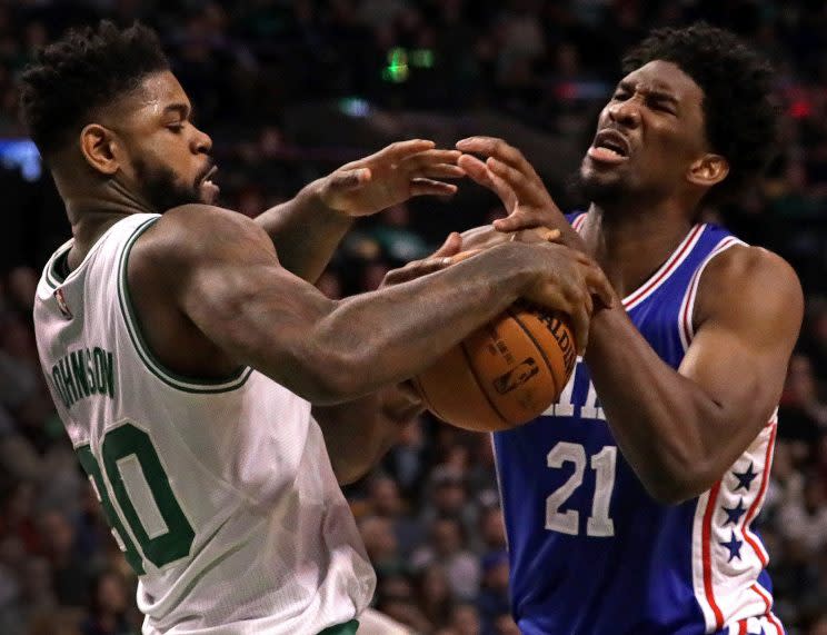 Amir Johnson gets acquainted with future teammate Joel Embiid. (Getty)