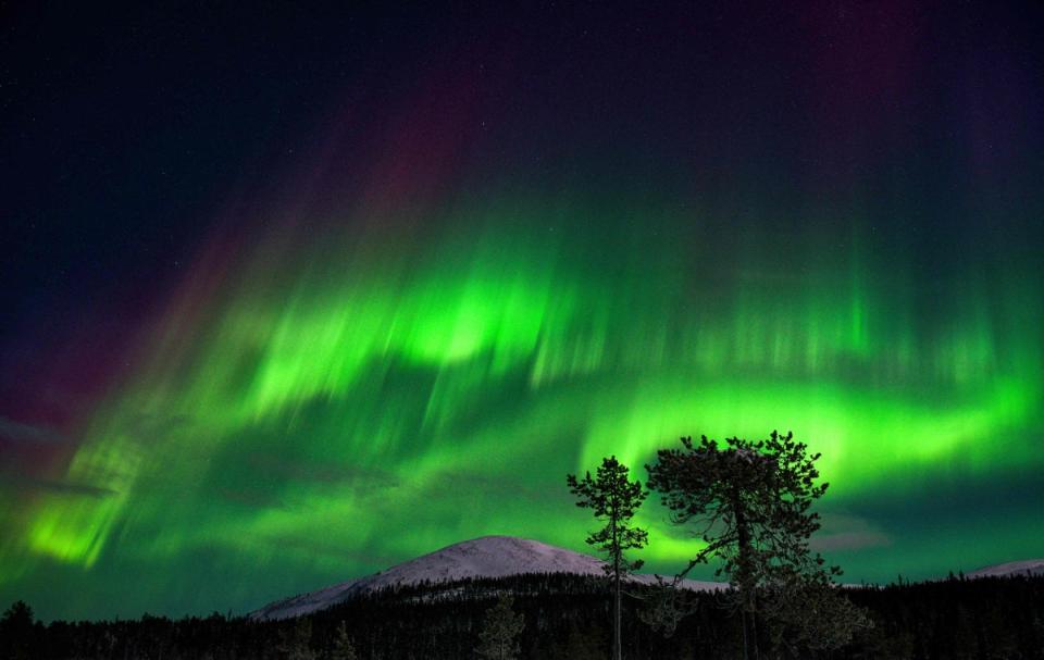 See the lights on snowmobiles or reindeer-drawn sleighs in Finnish Lapland (Lehtikuva/AFP via Getty Images)