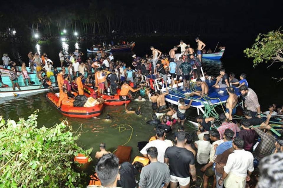 In this photograph taken on 7 May 2023, people carry out rescue operation at the site of a boat accident in Tanur, in Malappuram district of India’s Kerala state (AFP via Getty Images)