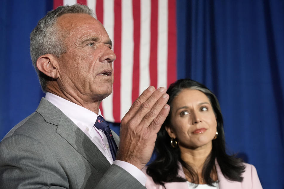 Former Independent candidate for president Robert F. Kennedy, Jr., left, answers a question as former Democratic Rep. Tulsi Gabbard listens as they meet with the media after a campaign event for Republican presidential nominee former President Donald Trump, Saturday, Sept. 14, 2024, in Glendale, Ariz. (AP Photo/Ross D. Franklin)