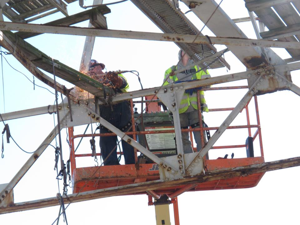 Workers use a blow torch to dismantle a large billboard on the beach in Atlantic City N.J. on Nov. 14, 2012. They were making way for the $35 million Margaritaville entertainment complex at Resorts Casino Hotel. Construction crews started work on the Margaritaville project at Resorts Casino Hotel, in what casino president Gary Van Hettinga called a vote of confidence in the seaside resort's long-term viability. (AP Photo/Wayne Parry)