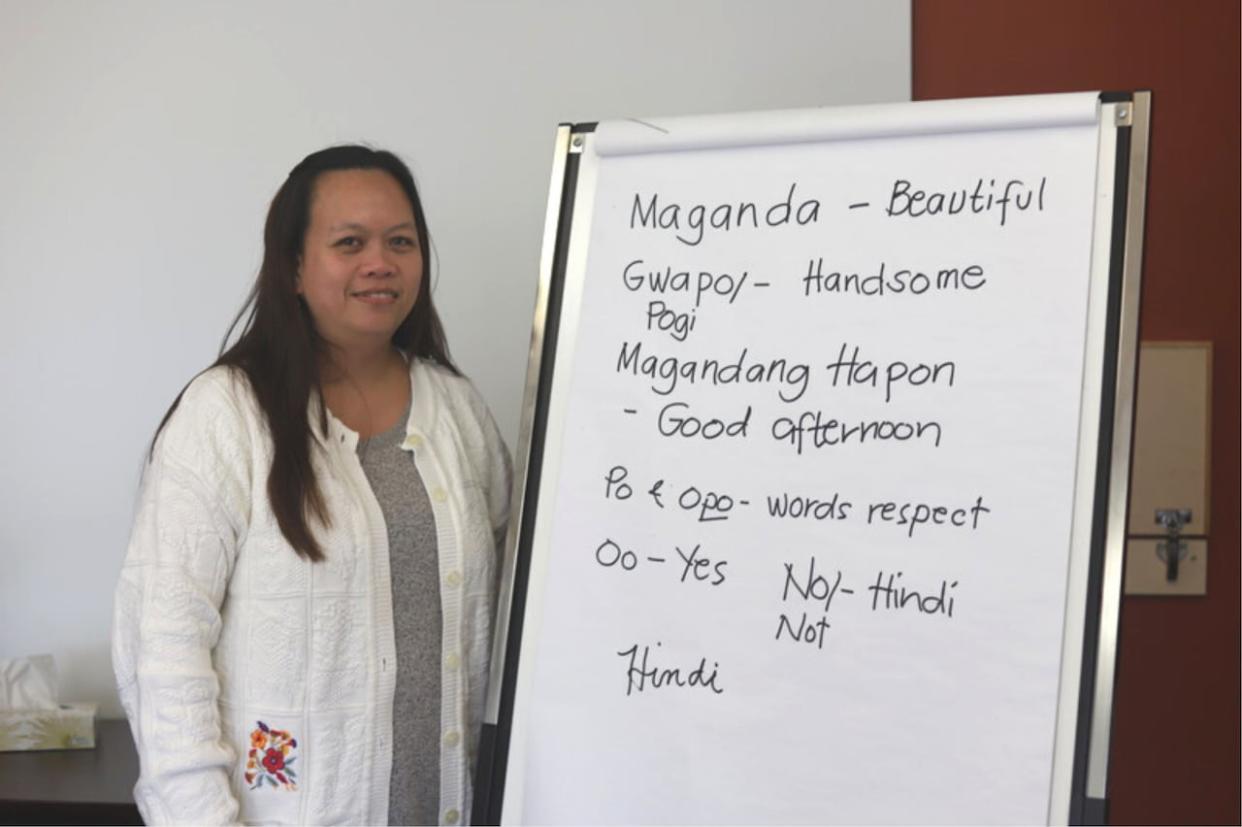 Julie Mabana shows some common phrases in the Filipino language, Tagalog. (Victoria Walton/CBC - image credit)