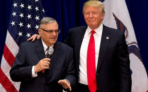 Donald Trump is joined by Maricopa County, Ariz., Sheriff Joe Arpaio at a campaign event - Credit: Mary Altaffer/AP