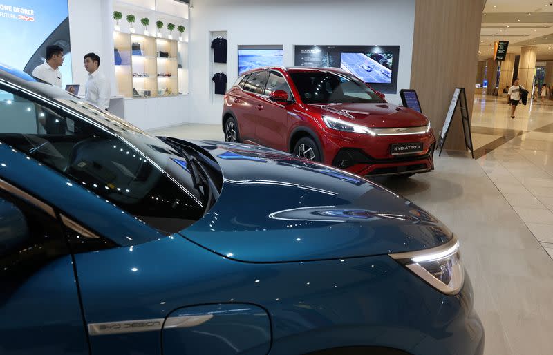 BYD electric vehicles are displayed at a BYD By 1826 cafe and car dealership in Singapore