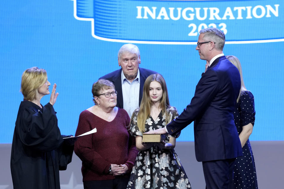 Illinois Treasurer Michael Frerichs, right, takes the oath of office from Mary Kay O'Brien, Illinois Supreme Court Associate Justice as his family watches during ceremonies Monday, Jan. 9, 2023, in Springfield, Ill. (AP Photo/Charles Rex Arbogast)