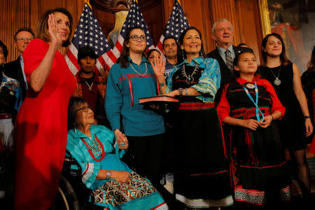 U.S. Representative Deb Haaland (D-NM) and her family pose for a ceremonial photograph with Speaker Nancy Pelosi (D-CA) after being sworn in as one of the first two Native American women in the U.S. House of Representatives at the U.S. Capitol in Washington, U.S., January 3, 2019. REUTERS/Brian Snyder