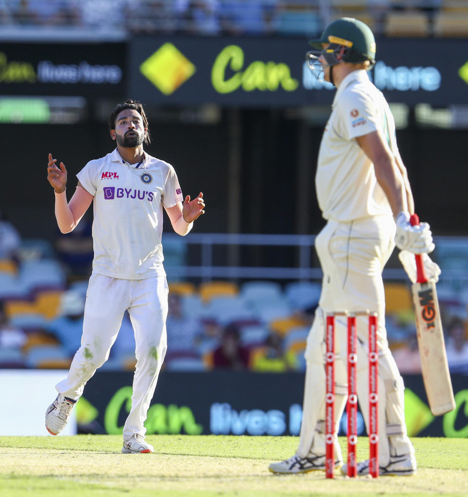 India's Mohammed Siraj, left, reacts after bowling to Australia's Cameron Green during play on the first day of the fourth cricket test between India and Australia at the Gabba, Brisbane, Australia, Friday, Jan. 15, 2021. (AP Photo/Tertius Pickard)