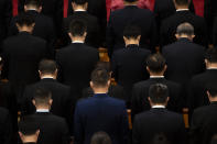 Attendees bow their heads during a momet of silence at an event to honor some of those involved in China's fight against COVID-19 at the Great Hall of the People in Beijing, Tuesday, Sept. 8, 2020. Chinese leader Xi Jinping is praising China's role in battling the global coronavirus pandemic and expressing support for the U.N.'s World Health Organization, in a repudiation of U.S. criticism and a bid to rally domestic support for Communist Party leadership. (AP Photo/Mark Schiefelbein)