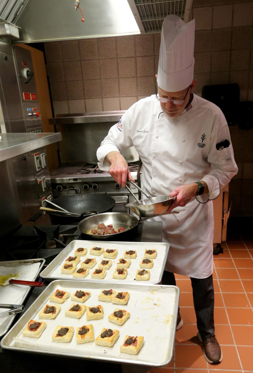 Chef Brent Spring, head of the Ivy Tech culinary arts program, completes the creation of Beef Wellington bites Monday, Feb. 13, 2023, at a gathering at Ivy Tech’s culinary arts area for a food tasting and food pairing with wine and spirits.