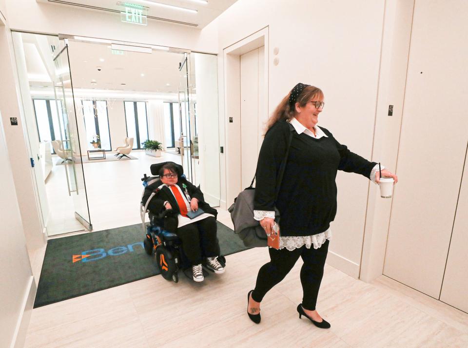 Megan Parker, left, and her mother Jaclyn Sims go to Parker's office in the Benesch law firm in downtown Cleveland. Sims accompanies her daughter to work to help with her medical care.