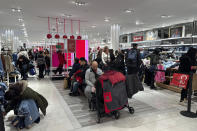 Black Friday shoppers look through merchandise at Macy's in Herald Square on Friday, Nov. 24, 2023, in New York. (AP Photo/Anne D'Innocenzio)