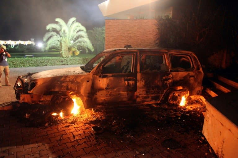 A vehicle sits smoldering in flames inside the US consulate compound in Benghazi, Libya on September 11, 2012 after an attack that killed four Americans, including Ambassador Christopher Stevens