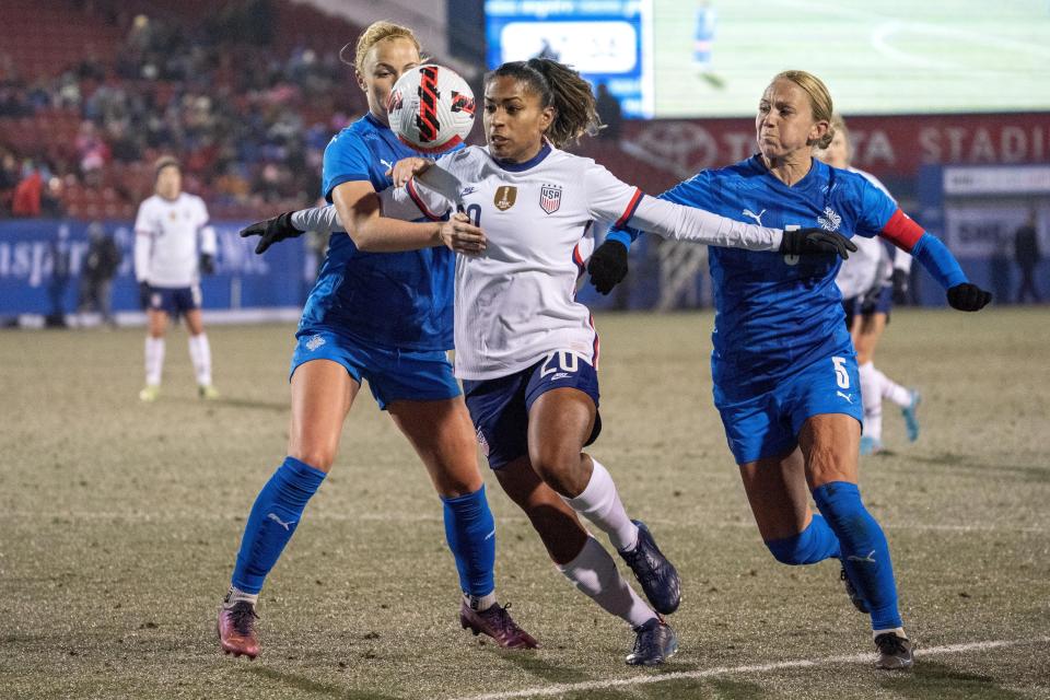 U.S. forward Catarina Macario fights past Iceland defender Glodis Perla Viggosdottir and midfielder Gunnhildur Jonsdottir (5) during the first half of a SheBelieves Cup soccer match Wednesday, Feb. 23, 2022, in Frisco, Texas. (AP Photo/Jeffrey McWhorter)