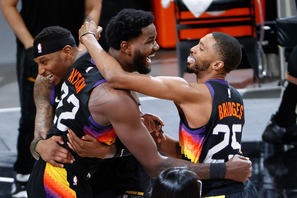 Deandre Ayton (22) Torrey Craig (12) and Mikal Bridges (25) celebrate a Game 2 win, and the Suns will try to clinch a Western Conference title on Monday. (Photo by Christian Petersen/Getty Images)