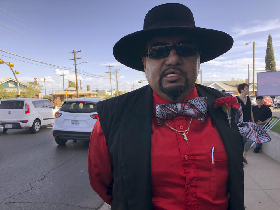 Jason Medina, 42, of El Paso, Texas, stands in line with thousands of others on Friday, Aug. 16, 2019, to pay respects to Margie Reckard, 63, who was killed by a gunman who opened fire at a Walmart in El Paso, Tex., earlier this month. Thousand of strangers from El Paso and around the country came this weekend to honor Reckard. Her long-time companion, Antonio Basco, says he felt so alone planning her funeral, that he invited the world to join him in remembering his companion of 22 years. (AP Photo/Russell Contreras)