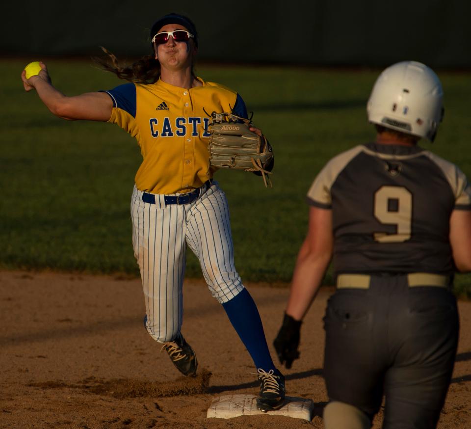 Castle's Jackie Lis (1) tags second base and throws to first to get the double-play against Central during their sectional championship game at North High School Saturday evening, May 28, 2022.