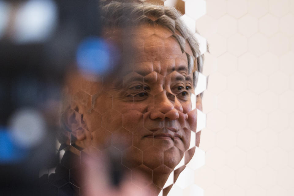 Indian Artist Anish Kapoor is mirrored as he stands in front of his sculpture 'Hexagon Mirror' at the exhibition 'Kapoor In Berlin' in the Martin-Gropius-Bau museum in Berlin, Friday, May 17, 2013. The exhibition will run from May 18, until Nov. 24, 2013. (AP Photo/Markus Schreiber)