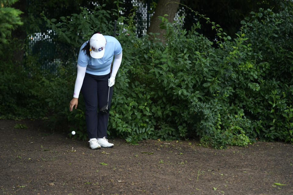 Angel Yin takes a drop after hitting into the brush on the first hole during the second round of the Women's PGA Championship golf tournament, Friday, June 23, 2023, in Springfield, N.J. (AP Photo/Seth Wenig)