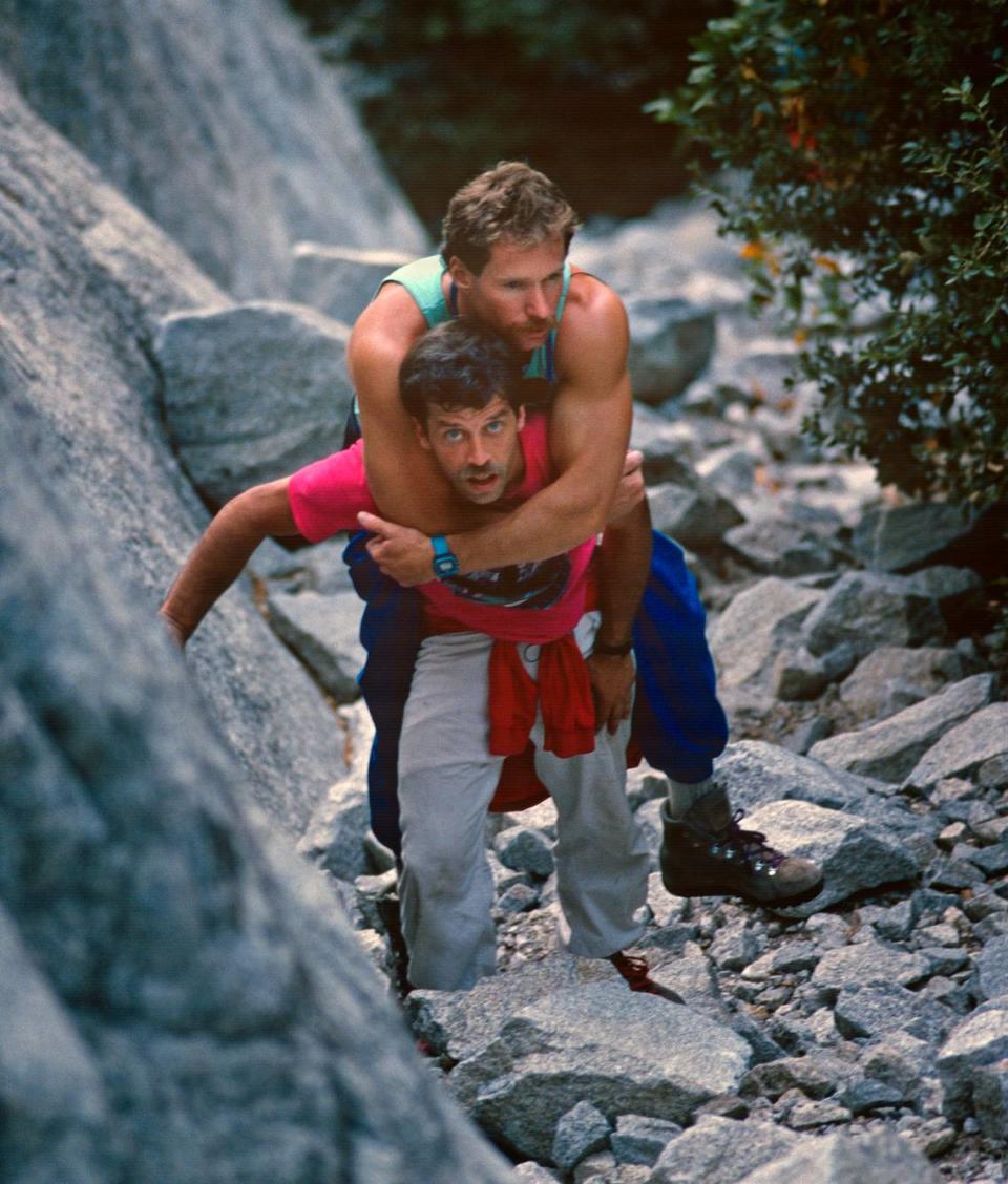 Mike Corbett carries Mark Wellman to the beginning of the Shield Route on El Capitan, July 1989. Wellman became the first paraplegic climber to ascend the granite monolith during an eight-day climb.