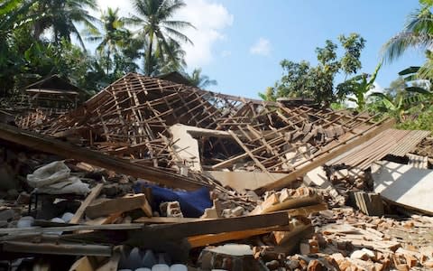 Houses damaged by an earthquake are seen in North Lombok, Indonesia - Credit: AP