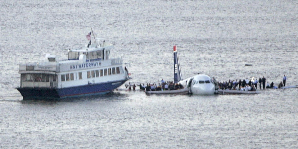 Image: Passengers stand on the wings of a U.S. Airways plane as a ferry pulls up to it after it landed in the Hudson River in New York (Gary Hershorn / Reuters)