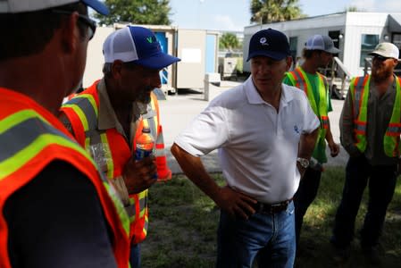 Eric Silagy, president and CEO of FPL, talks with workers ahead of the arrival of Hurricane Dorian in Daytona Beach