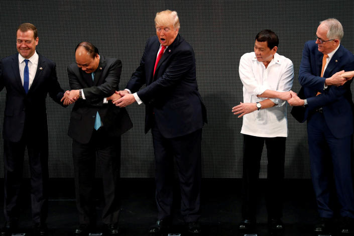 Trump registers his surprise as he&amp;nbsp;realizes other leaders, including Russia's Prime Minister Dmitry Medvedev, Vietnam's Prime Minister Nguyen Xuan Phuc, President of the Philippines Rodrigo Duterte and Australia's Prime Minister Malcolm Turnbull, are crossing their arms for the traditional &quot;ASEAN handshake&quot; as he participates in the opening ceremony of the ASEAN Summit in Manila, Philippines,&amp;nbsp;on Nov. 13.