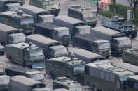 Military vehicles are parked on the grounds of the Shenzhen Bay Sports Center in Shenzhen