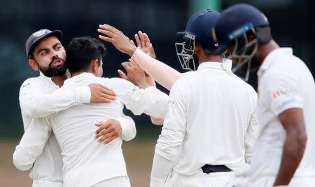 Cricket - Sri Lanka v India - Second Test Match - Colombo, Sri Lanka - August 6, 2017 - India's captain Virat Kohli, Ravindra Jadeja and Cheteshwar Pujara celebrate the dismissal of Sri Lanka's captain Dinesh Chandimal. REUTERS/Dinuka Liyanawatte