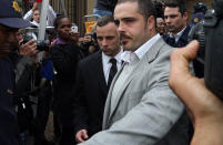 Oscar Pistorius, centre, leaves the high court in Pretoria, South Africa, Monday, April 14, 2014. Pistorius is charged with murder for the shooting death of his girlfriend, Reeva Steenkamp, on Valentines Day in 2013. (AP Photo/Themba Hadebe)