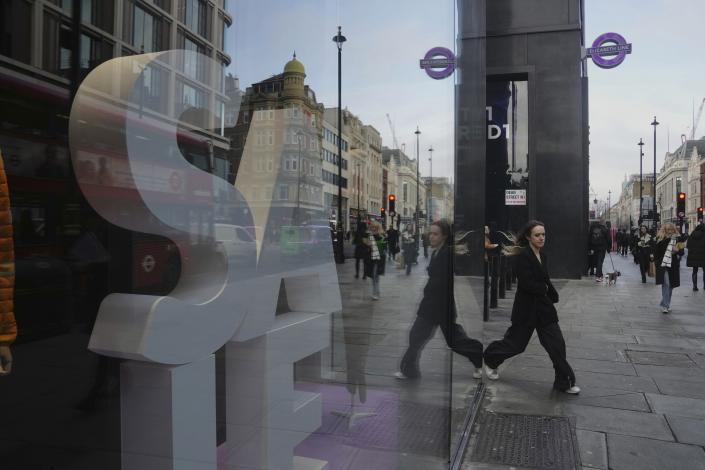 A woman walks along a street in a shopping district in central London, Thursday, Feb. 2, 2023. The Bank of England is expected to raise interest rates by as much as half a percentage point Thursday as it seeks to tame the double-digit inflation fueling a cost-of-living crisis, public-sector strikes and fears of recession. (AP Photo/Kin Cheung)