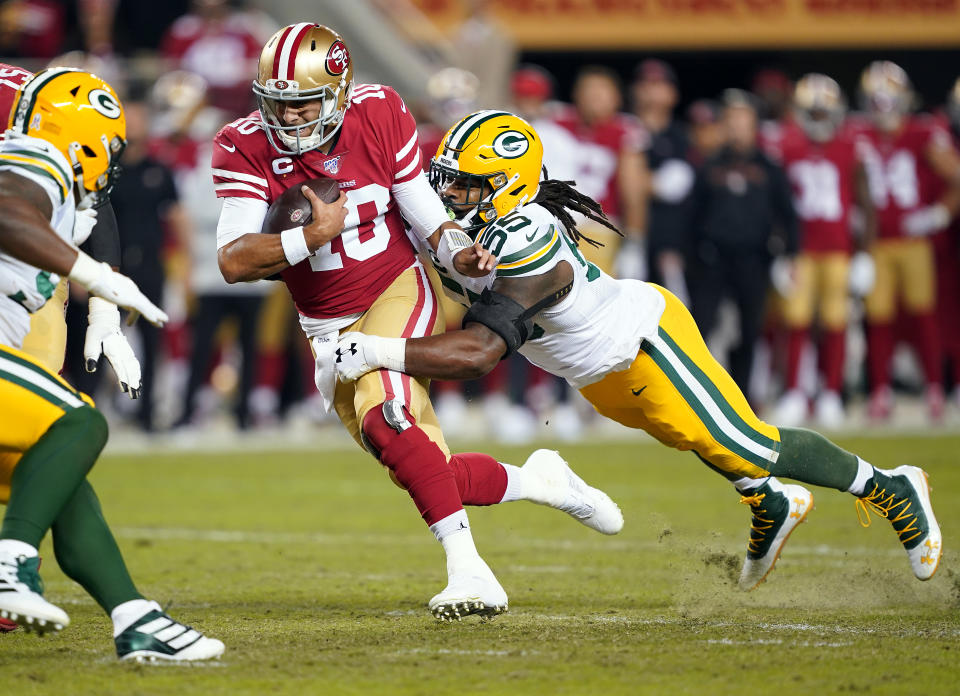 SANTA CLARA, CALIFORNIA - NOVEMBER 24:  Quarterback Jimmy Garoppolo #10 of the San Francisco 49ers is chased by outside linebacker Za'Darius Smith #55 of the Green Bay Packers during the first quarter of the game at Levi's Stadium on November 24, 2019 in Santa Clara, California. (Photo by Thearon W. Henderson/Getty Images)