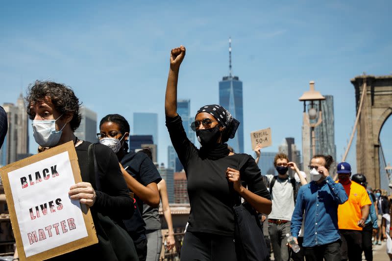 Current and former New York City Mayor's staff march across the Brooklyn Bridge to call for reforms during a protest against racial inequality in the aftermath of the death in Minneapolis police custody of George Floyd, in New York