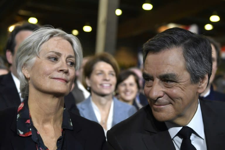 French right-wing candidate for the upcoming presidential election Francois Fillon (R) flanked by his wife Penelope (L), looks on during a campaign rally in Paris in January 2017