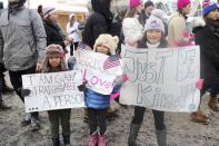 Kona Burton, age 5, Maile Burton, age 7, and Keilani Burton, 9, (L-R) from Midway, Utah, hold their signs during a protest against new U.S. President Donald Trump during the Sundance Film Festival, in solidarity with the Women's March protests being held around the world, in Park City, Utah, U.S. January 21, 2017. REUTERS/Piya Sinha-Roy