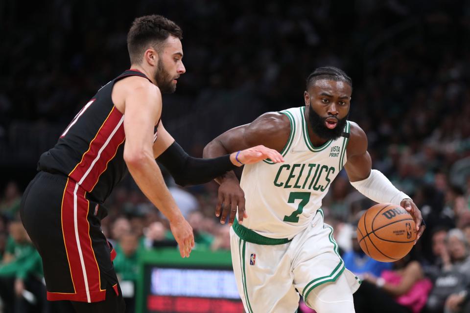 The Boston Celtics' Jaylen Brown drives to the basket while defended by the Miami Heat's Max Strus.