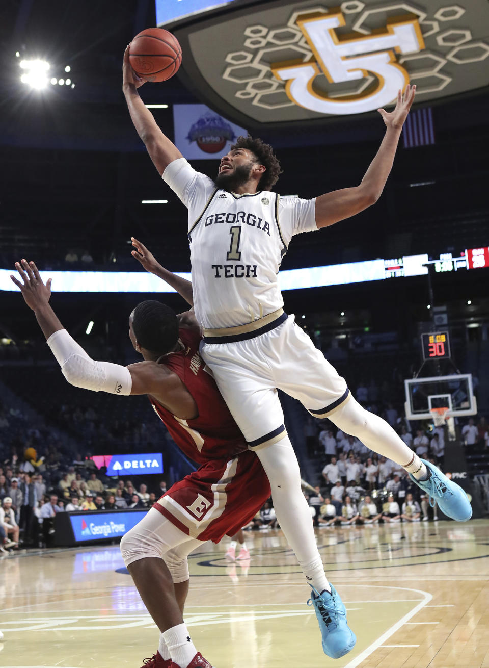 Georgia Tech forward James Banks III gets the offensive rebound over Elon forward Federico Poser during the second half of an NCAA college basketball game on Monday, Nov. 11, 2019, in Atlanta. Georgia Tech won, 64-41. (Curtis Compton/Atlanta Journal-Constitution via AP)