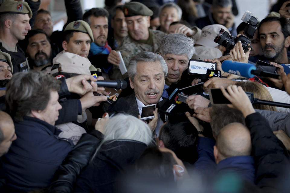 Presidential candidate Alberto Fernandez, representing the "Frente de Todos" political party, talks to journalist after casting his vote during primary elections in Buenos Aires, Argentina, Sunday, Aug. 11, 2019. Argentina is holding primary elections Sunday which are expected to provide a hint of who might win ahead of October's presidential elections. (AP Photo/Sebastian Pani)