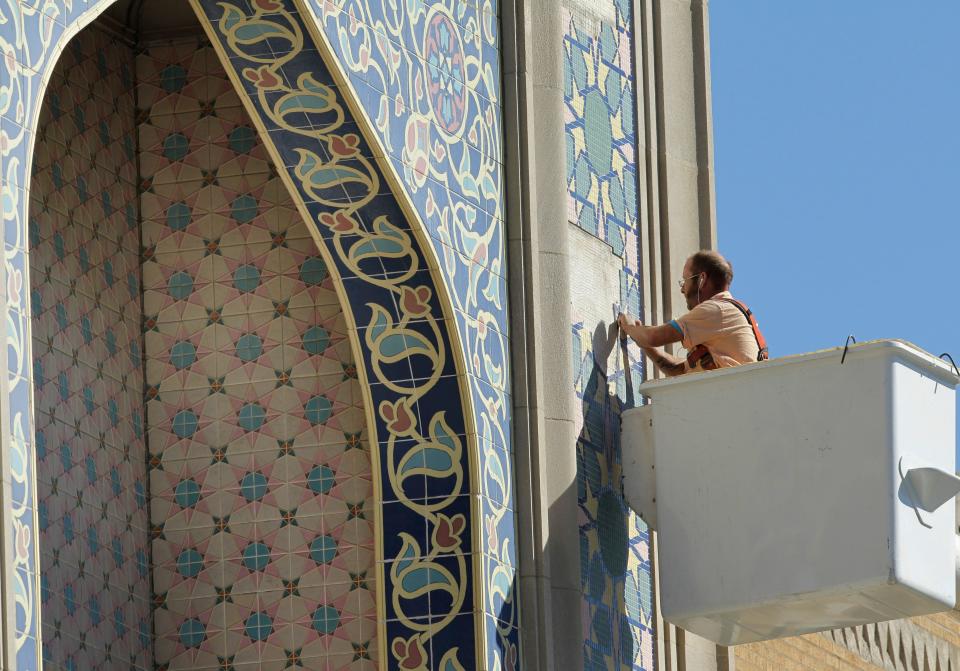 Spray-O-Bond employee Jonas Haferman performs tile restoration work Monday, October 7, 2013 on the exterior of the historic Tripoli Shrine Temple, 3000 W. Wisconsin Ave. in Milwaukee, Wis. The building, on the National Register of Historic Places, was dedicated in 1928 and is home to a Masonic order.