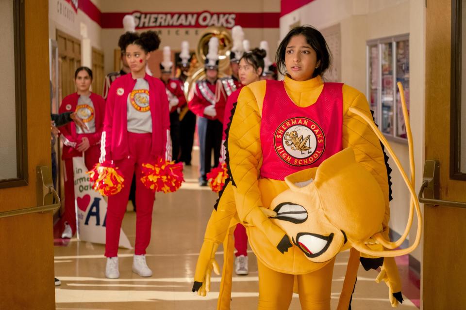 Devi wearing a mascot costume in the high school hallway