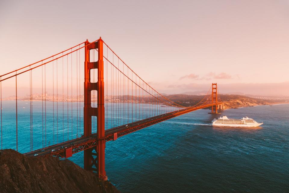 Beautiful panorama view of cruise ship passing famous Golden Gate Bridge