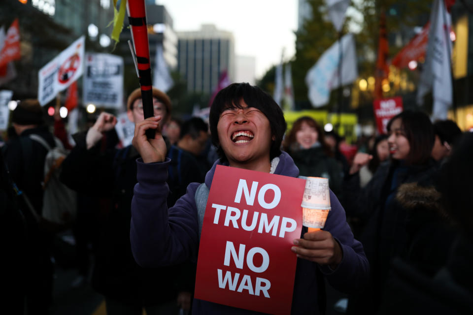 <p>A demonstrator holds a placard reading ‘No Trump No War’ during a protest ahead of President Donald Trump’s visit near the U.S. Embassy in Seoul, South Korea, on Saturday, Nov. 4, 2017. (Photo: Seong Joon Cho/Bloomberg via Getty Images) </p>