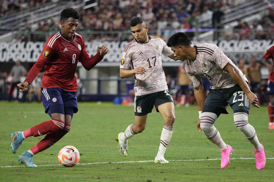 Costa Rica midfielder Josimar Alcócer (8) controls the ball in front of Mexico midfielder Orbelín Pineda (17) and defender Jesús Gallardo (23) during the first half of a CONCACAF Gold Cup soccer quarterfinal Saturday, July 8, 2023, in Arlington, Texas. (AP Photo/Sam Hodde)