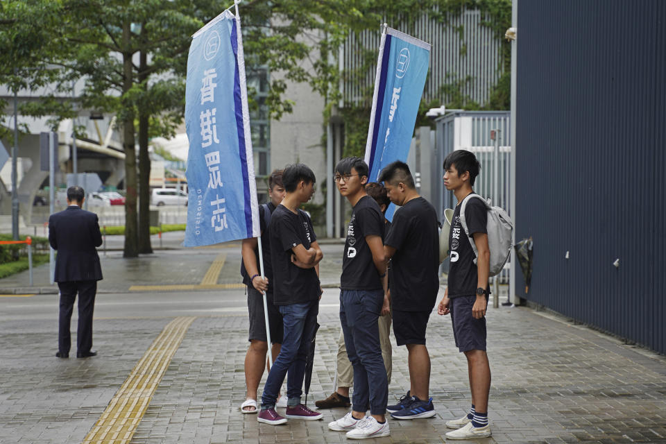 Issac Cheng, vice-chairperson of Demosisto, wearing glasses, stands with other members before a press conference in Hong Kong Friday, Aug. 30, 2019. Demosisto, a pro-democracy group in Hong Kong, posted on its social media accounts that well-known activist Wong had been pushed into a private car around 7:30 a.m. Friday and was taken to police headquarters. It later said another member, Agnes Chow, had also been arrested, at her home. (AP Photo/Vincent Yu)