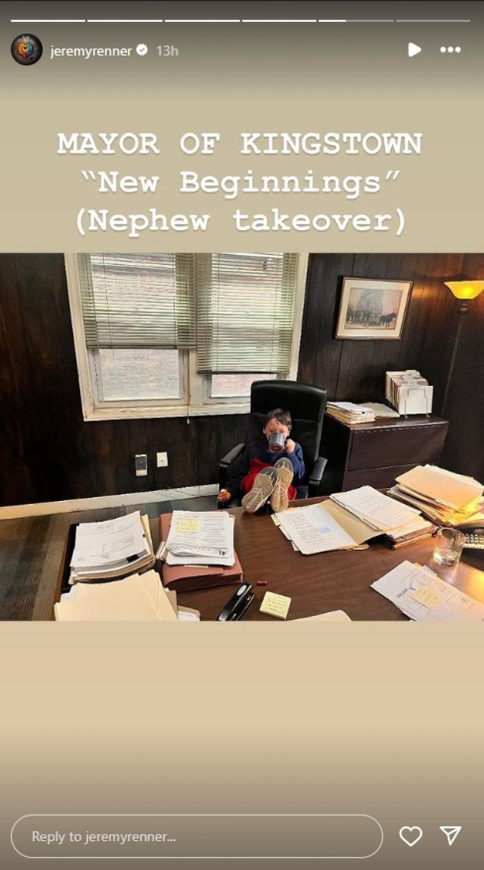 Jeremy Renner's nephew sitting with his feet on a desk drinking out of a coffee cup on the set of Mayor of Kingstown. Caption says: Mayor of Kingstown 