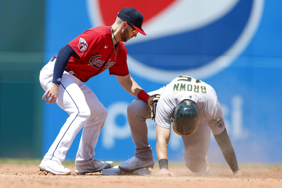 Oakland Athletics' Seth Brown (15) steals second base as Cleveland Guardians' Owen Miller applies a late tag during the sixth inning of a baseball game, Sunday, June 12, 2022, in Cleveland. (AP Photo/Ron Schwane)