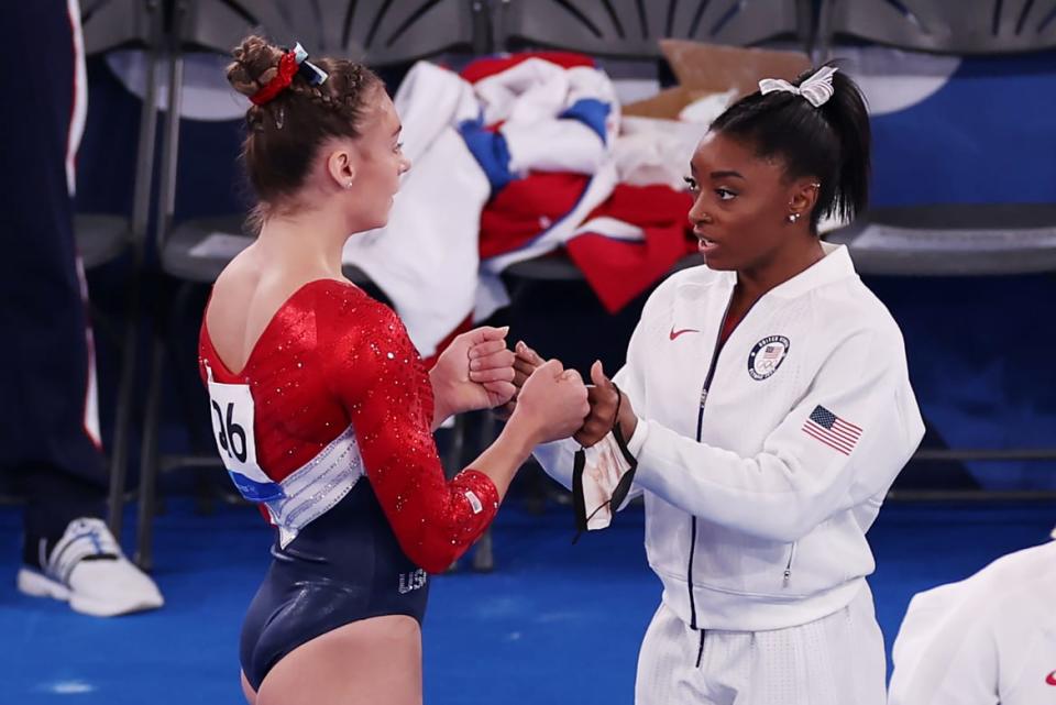 <div class="inline-image__caption"><p>Simone Biles fist-bumps Grace McCallum before her floor exercise during the team final.</p></div> <div class="inline-image__credit">Jamie Squire/Getty</div>